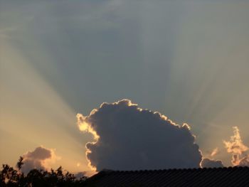 Low angle view of silhouette house against sky during sunset