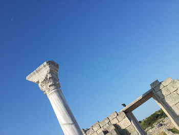 Low angle view of tower against blue sky