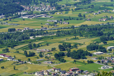 High angle view of houses and trees on field