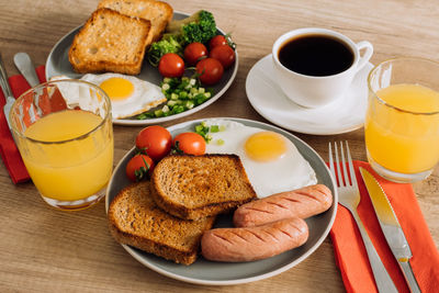 Grilled sausage and whole wheat toast with fried egg and cherry tomatoes, english breakfast