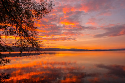 Scenic view of lake against romantic sky at sunset