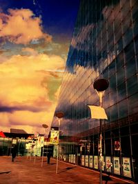 View of illuminated buildings against sky at sunset