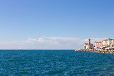 Scenic view of sea against clear blue sky