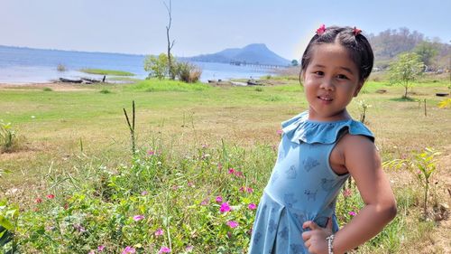 Portrait of boy standing on field