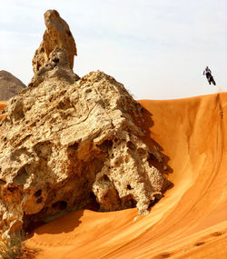 Sending it. rock formations in desert against sky