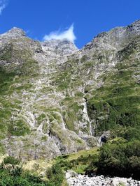 Scenic view of waterfall against sky