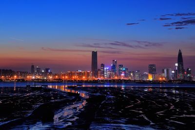 Illuminated city at waterfront