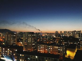 High angle view of illuminated buildings in city at night