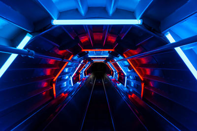 Illuminated tunnel at night