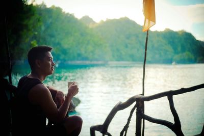 Man sitting by lake