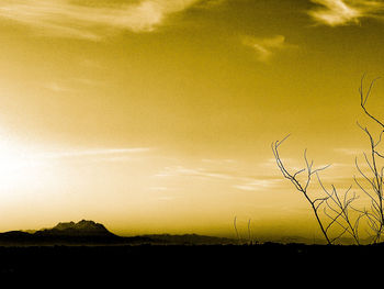 Scenic view of silhouette field against sky during sunset