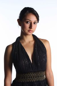 Portrait of beautiful young woman standing against white background