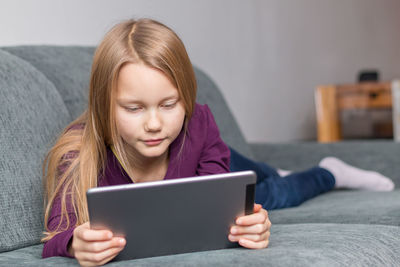 Mid adult woman using mobile phone at home