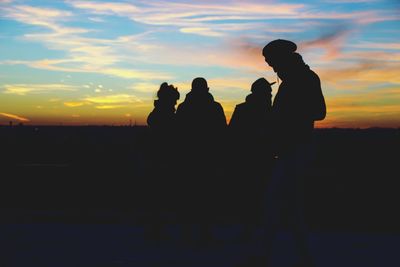 Silhouette people against sky during sunset