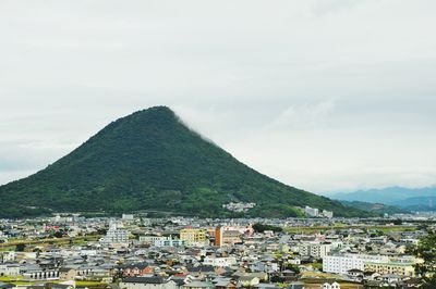 Town by mountains against sky