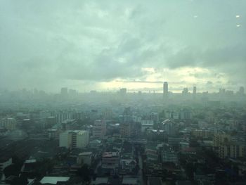 Cityscape against cloudy sky