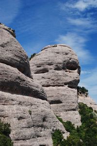 Low angle view of rock formations against sky