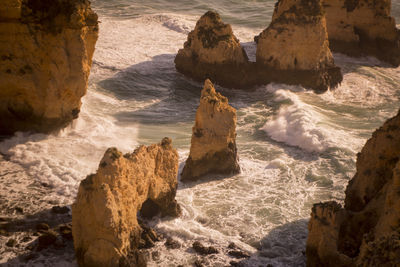 High angle view of rock formations in sea