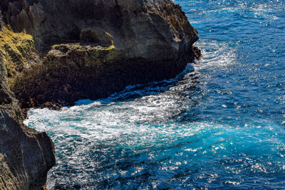 Sea waves splashing on rock