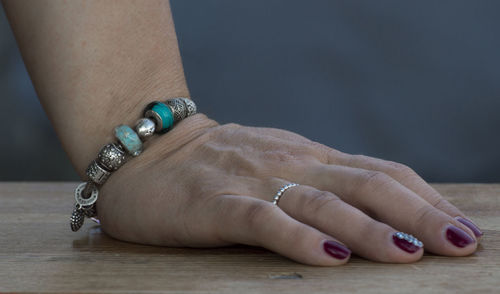 Cropped hand of woman wearing bracelet and nail polish
