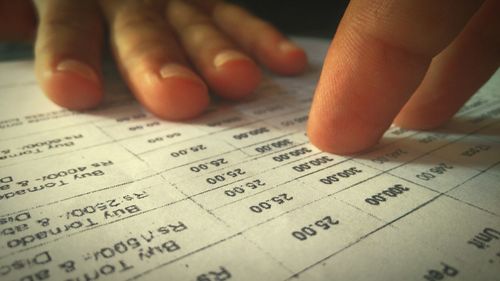 Cropped image of hands on financial bill