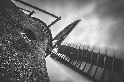 Low angle view of traditional windmill against sky