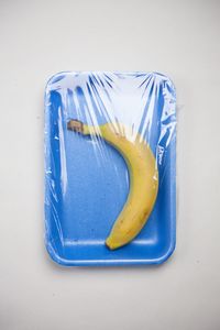 High angle view of fruit in plate against white background