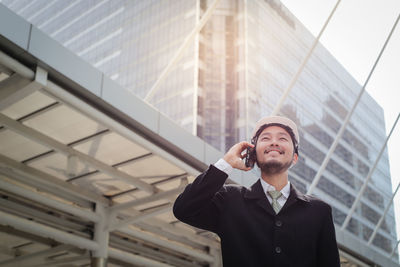 Full length of young man using mobile phone