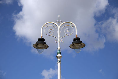 Low angle view of street light against cloudy sky