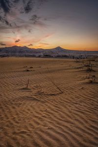 Scenic view of desert against sky during sunset
