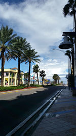 Empty road with buildings in background