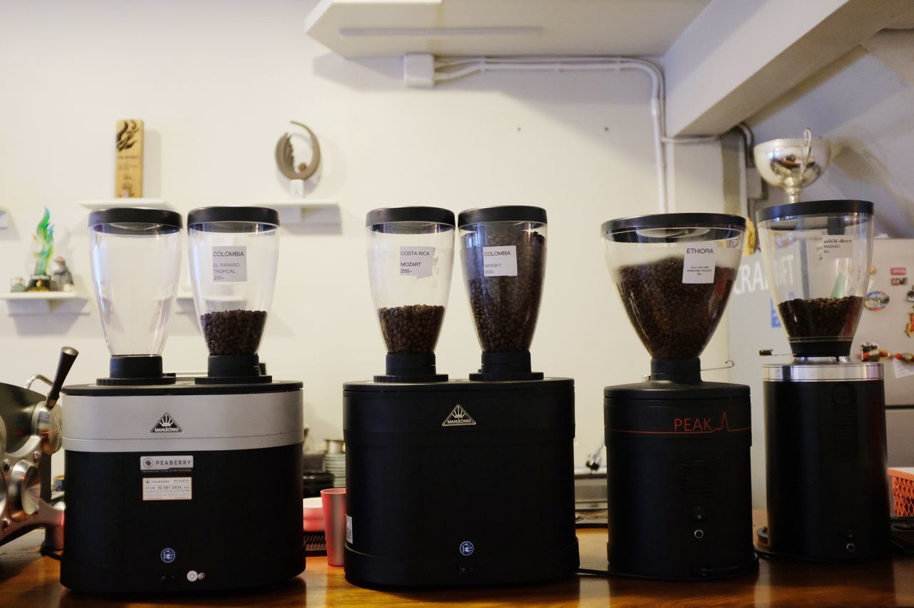 CLOSE-UP OF COFFEE CUPS ON TABLE AT HOME