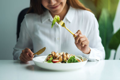 Midsection of woman holding food