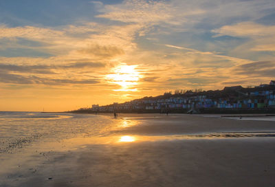 Scenic view of beach against sky during sunset