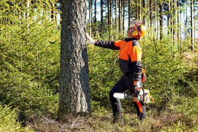 Man riding bicycle on tree trunk