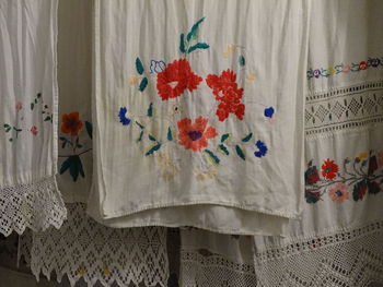 Close-up of multi colored curtain hanging on wall at home