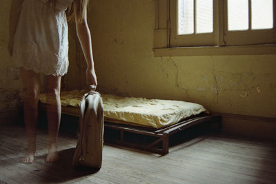 Woman standing by window at home