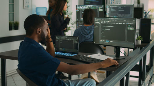 Side view of man working at office