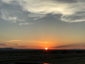 Scenic view of field against sky during sunset