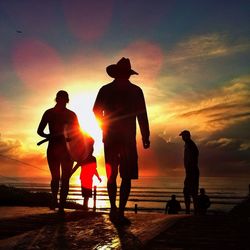 Silhouette of people at sunset