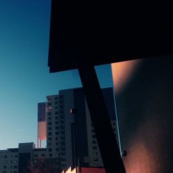 Low angle view of modern building against blue sky