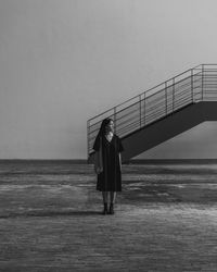 Full length portrait of woman standing on sea against sky