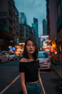 Portrait of woman standing in city