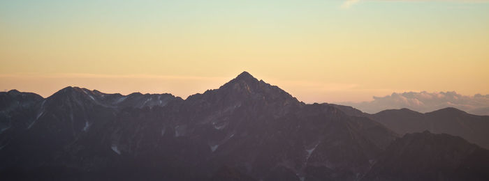 Scenic view of mountains against sky during sunset