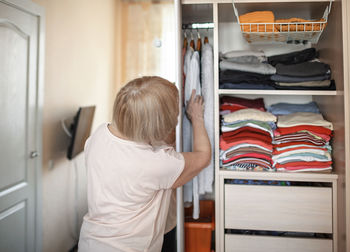 Senior woman looking at wardrobe