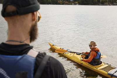 High angle view of man sitting in kayak on water