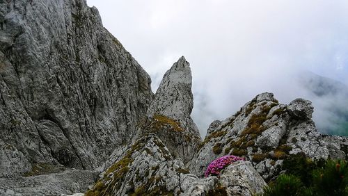 Low angle view of rocky mountains against sky