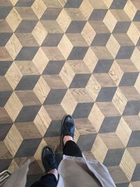 Low section of woman standing on tiled floor