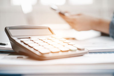 Midsection of person using laptop on table