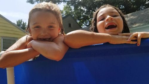 Portrait of happy girls playing in swimming pool